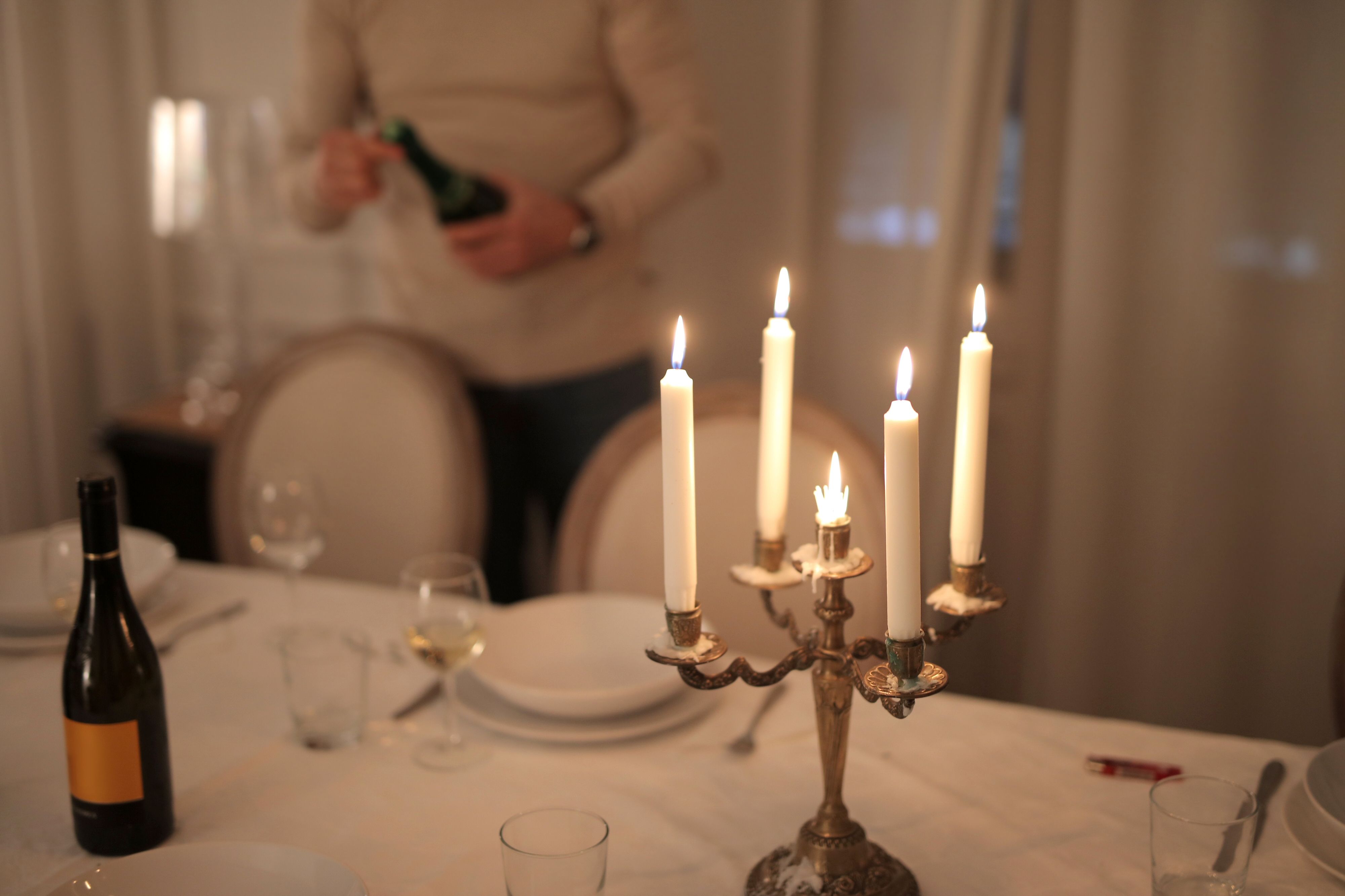 Refined candlelit dinner table setting with wine glasses for an intimate evening
