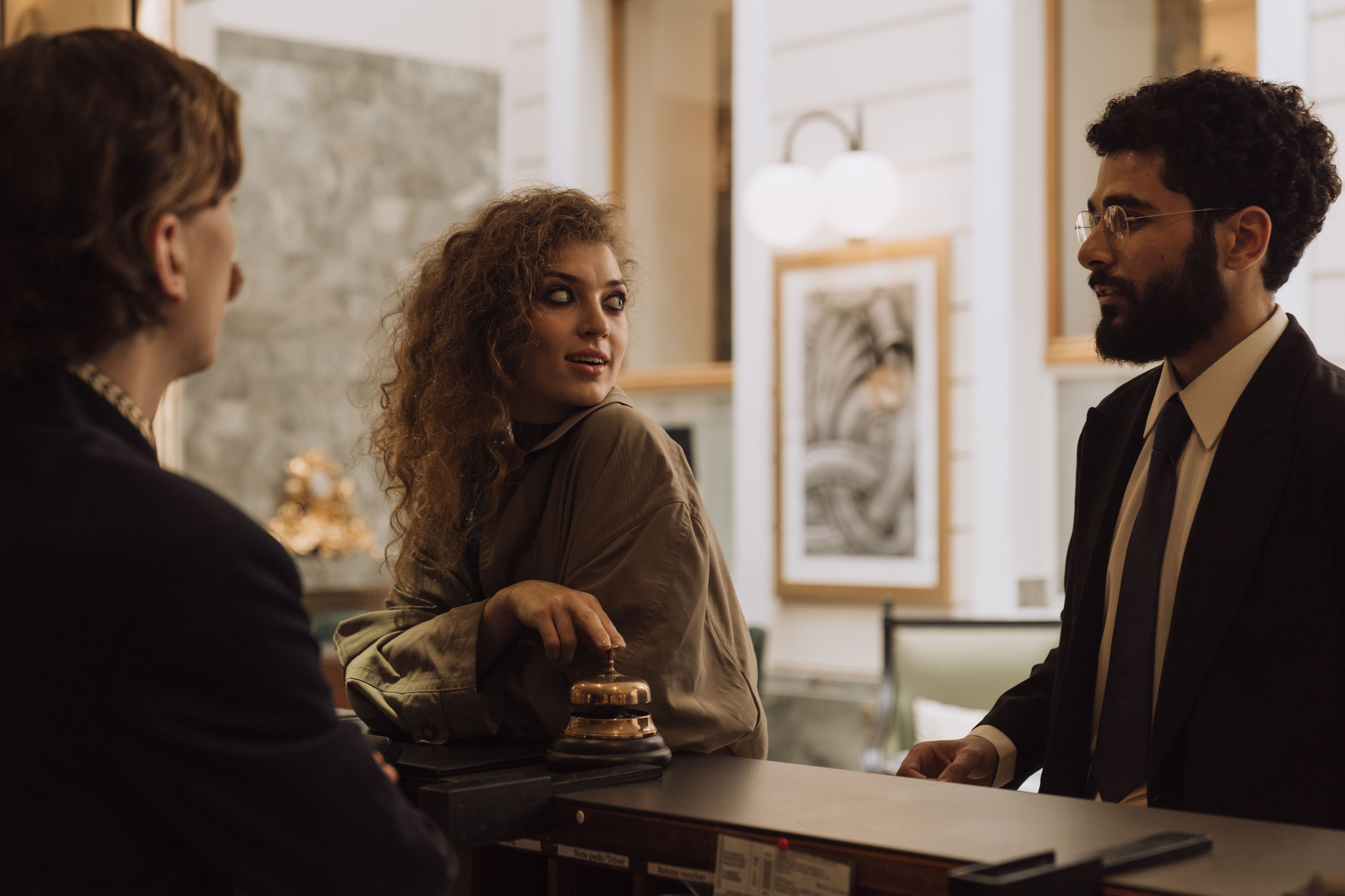 Hotel staff warmly welcoming guests at a luxurious reception desk