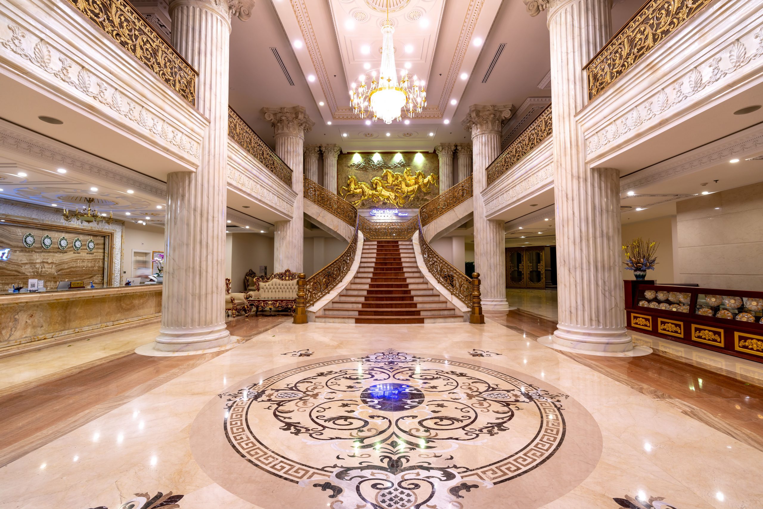 Elegant luxury hotel foyer with grand staircase, marble floors and dazzling chandelier